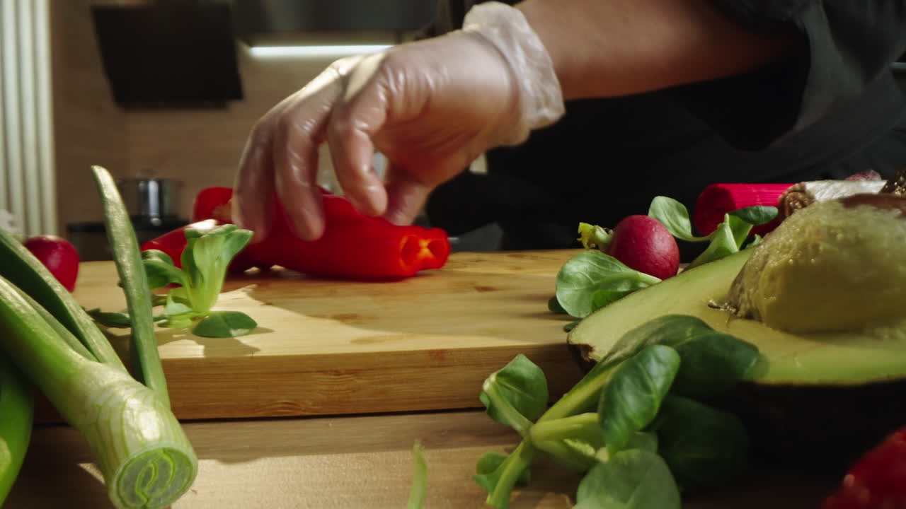 Close-up of Chef's Hands Preparing Fresh Vegetables on a Cutting Board