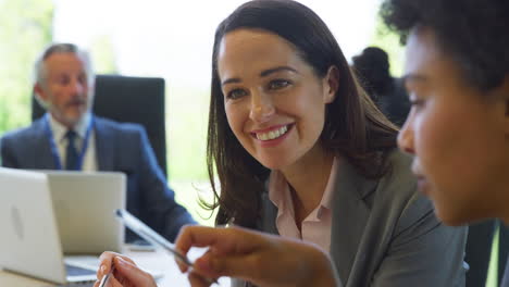 Multi-Cultural-Business-Team-Meeting-And-Collaborating-Around-Table-In-Modern-Office-Building