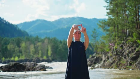 woman posing in nature, framing a scenic view
