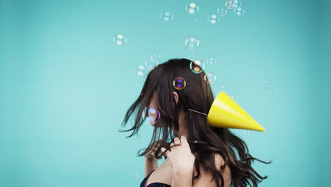 woman with party hat and bubbles