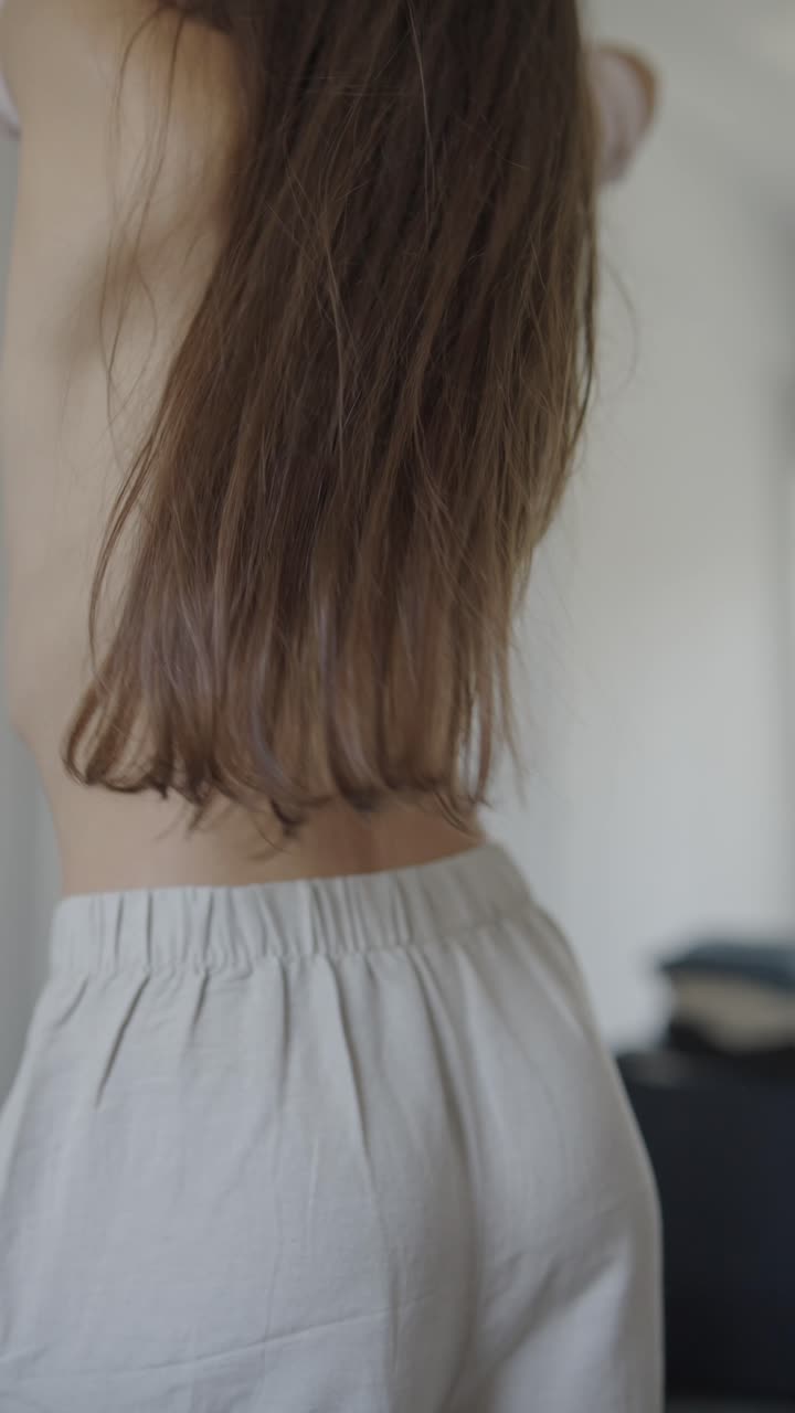 Woman putting on clothes