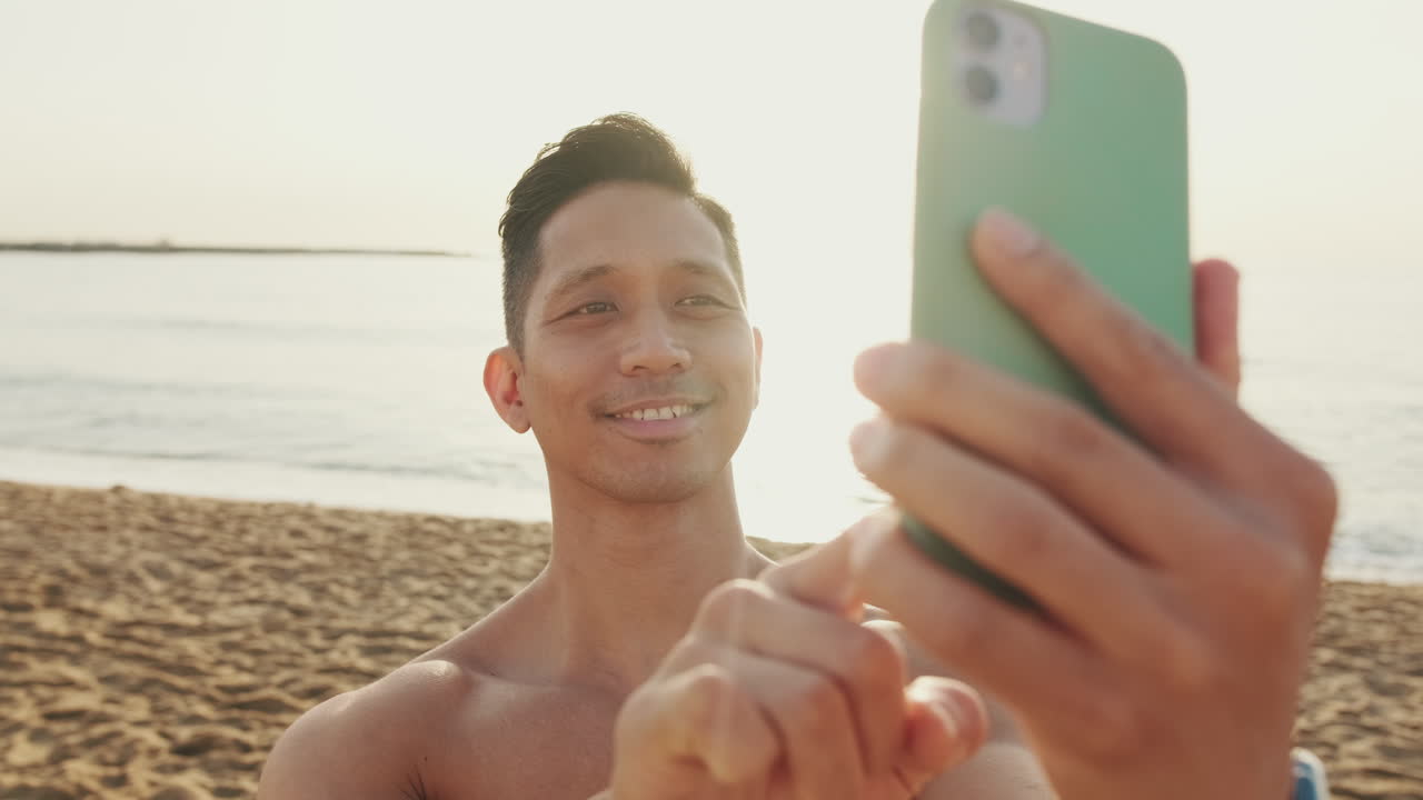 Uomo che si fa un selfie sulla spiaggia