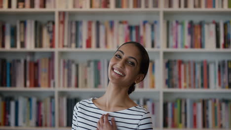 Retrato-Feliz-Joven-Estudiante-India-Riéndose-Disfrutando-De-Un-Logro-Educativo-Exitoso-Luciendo-Emocionado-En-El-Fondo-De-La-Librería-De-La-Biblioteca