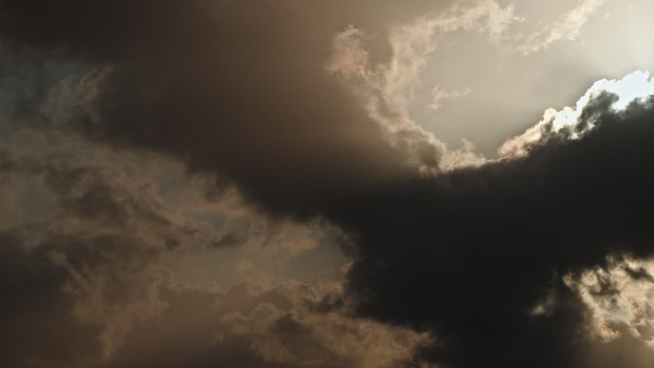 Timelapse of dramatic clouds moving across a bright sky