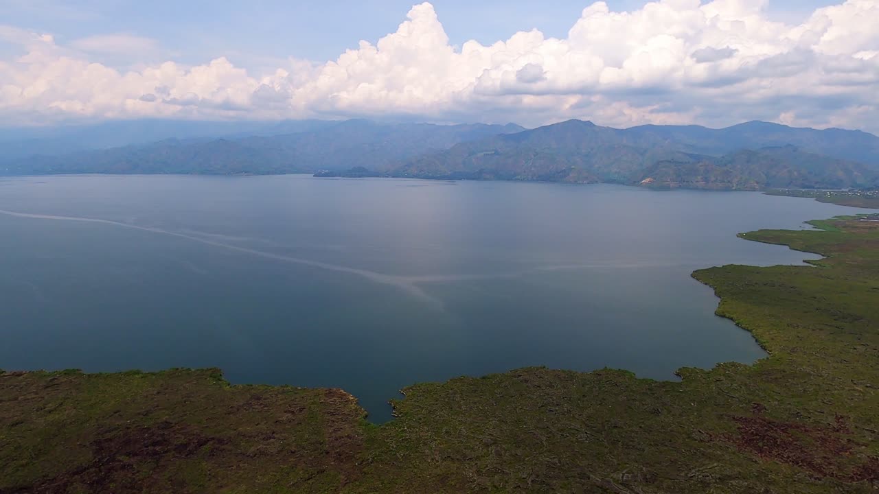 Wide angle aerial ocean view and green mountain background at day