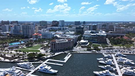 establishing drone shot of west palm beach marina, harbor and cityscape during the day in florida, usa