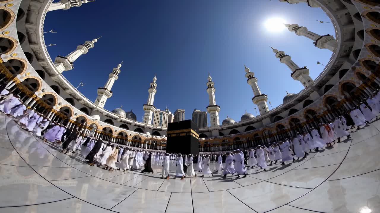 Fisheye view of pilgrims circling the Kaaba under a clear sky, capturing the vastness
