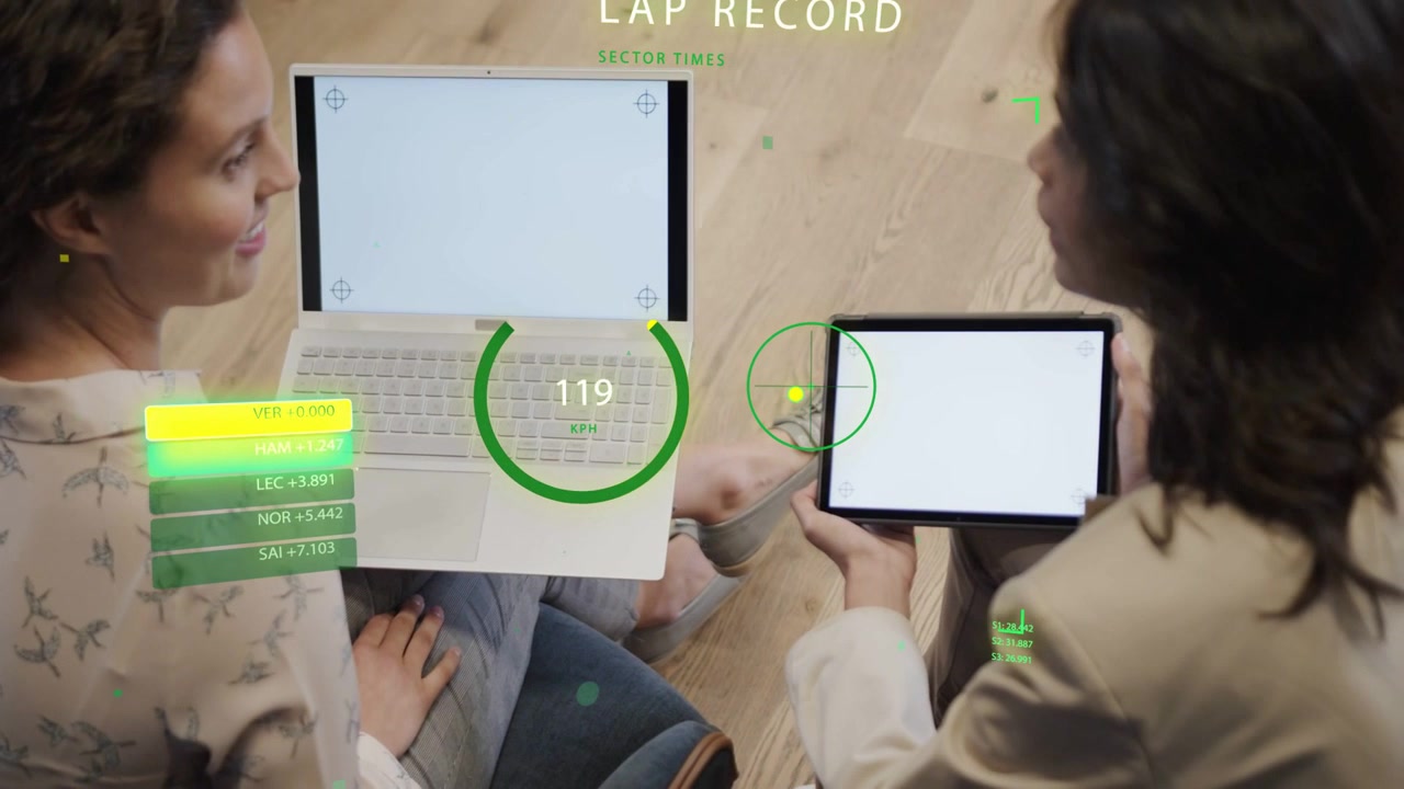 Vertical video: HUD updating, pair shifting laptop, angling tablet and checking readout on floor