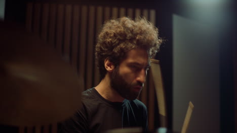 musician nodding head in studio. drummer making rock music in concert hall.