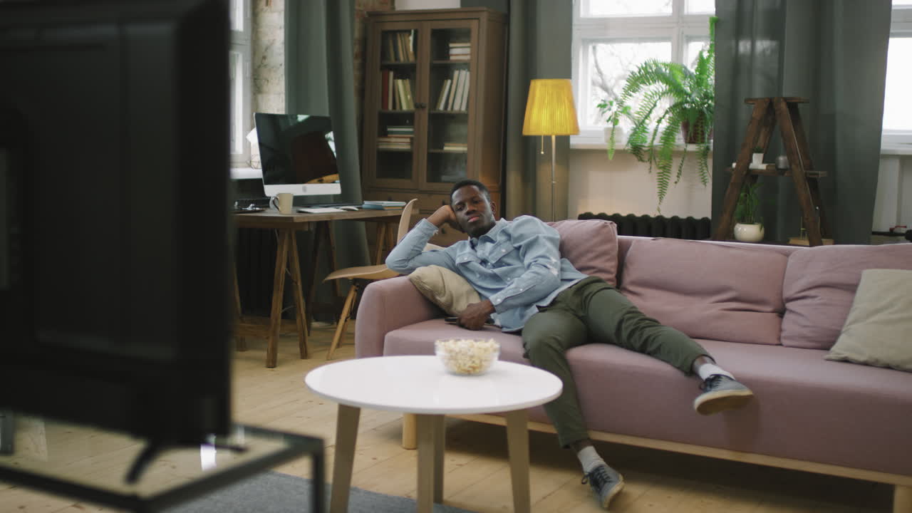 Afro Man Procrastinating In Front Of TV