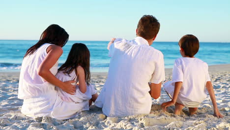 Family-sitting-on-the-beach