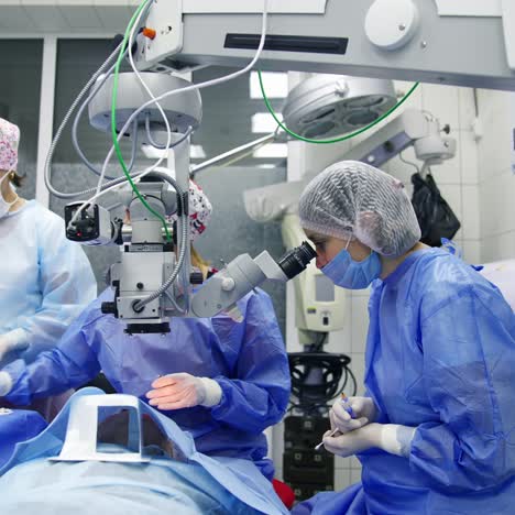 surgeon operating with surgical microscope