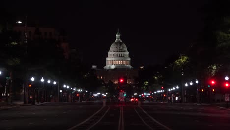 a nearly empty pennsylvania avenue in the middle of the night showing the national capital of the united states in washington, dc