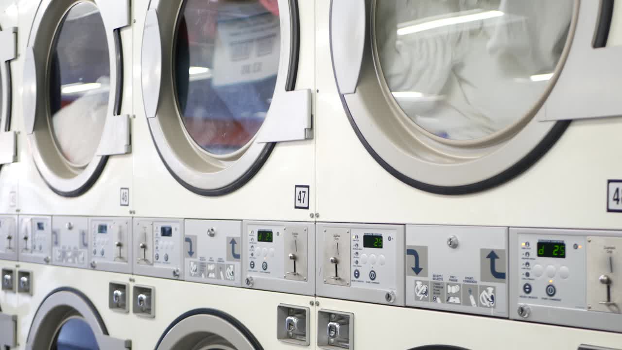 Washing machines, public coin laundry, USA. Self-service laundromat, laundrette.