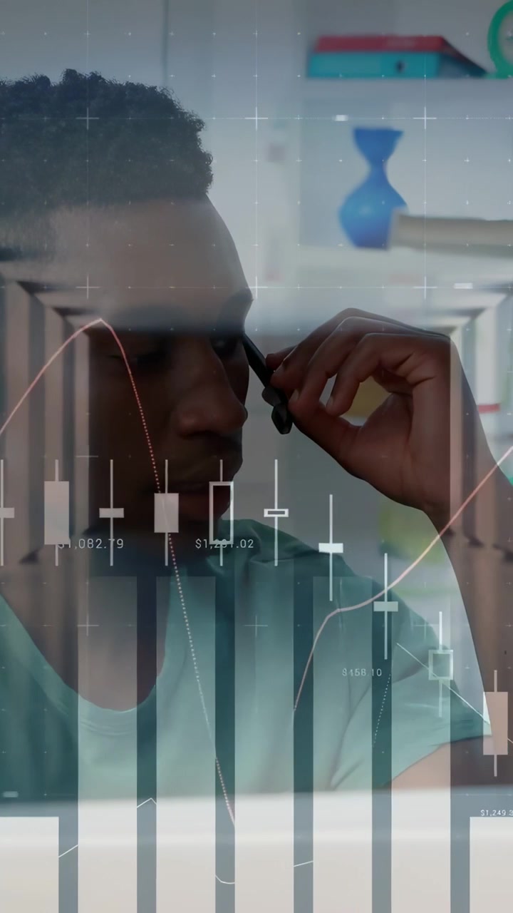 Man adjusting earpiece and joining call, monitoring animated candlestick charts for trading