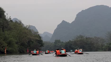 tourists rowing boats on a scenic river