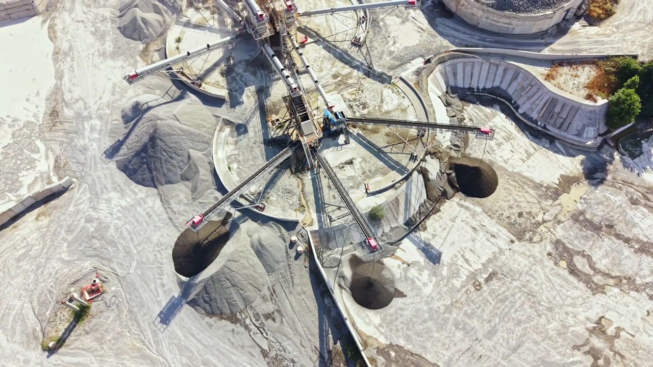 Granite quarry operation showing machinery and excavation in a large open site