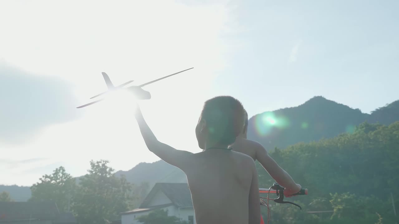 Children Playing with a Toy Airplane Outdoors