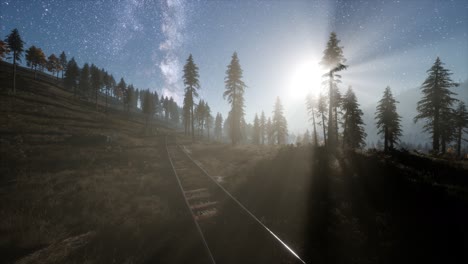 the milky way above the railway and forest