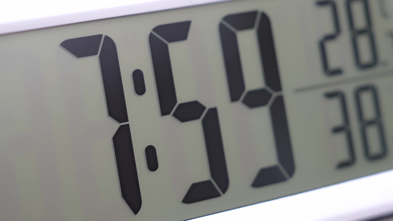 Close-up of a digital clock display highlighting precise timekeeping, modern technology, and everyday time management in a minimalist setting.