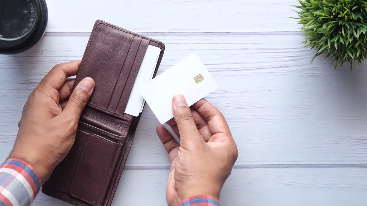 Person holding a wallet with credit card