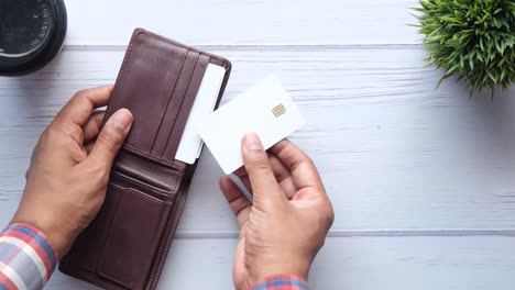 person holding a wallet with credit card