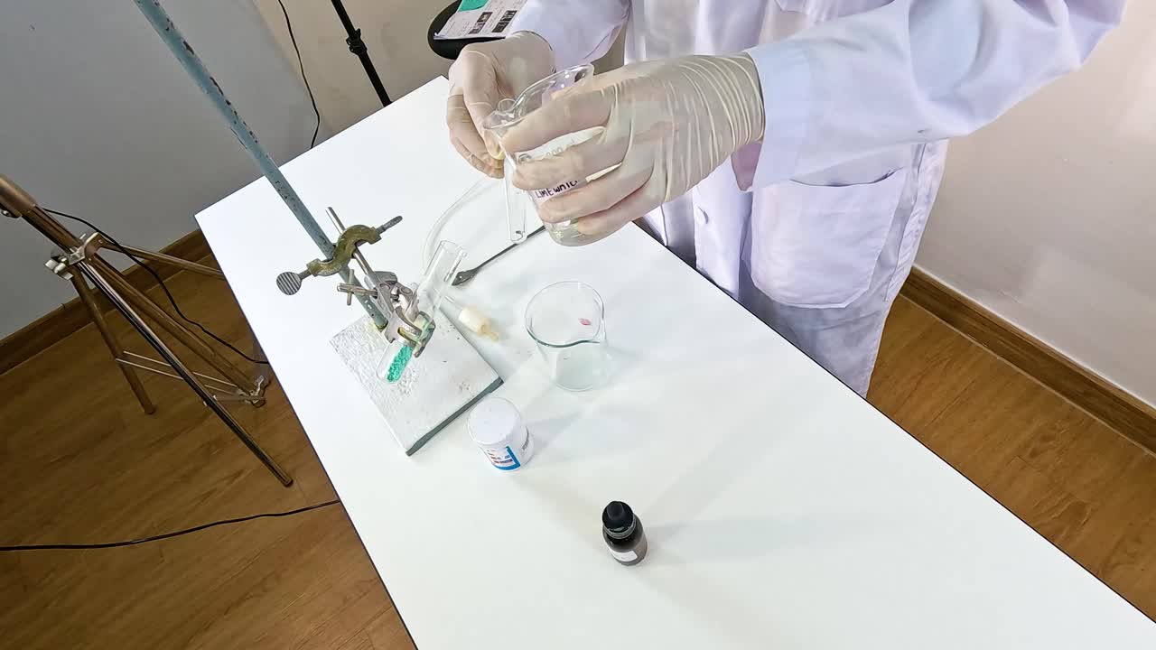 A scientist conducts a chemical reaction between copper carbonate and sulfuric acid in a laboratory setting