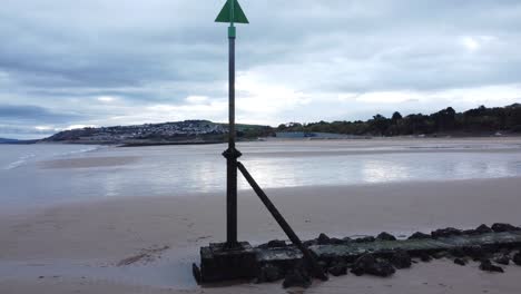 coastal tide marker aerial view low slow rising above moody overcast low tide seaside beach