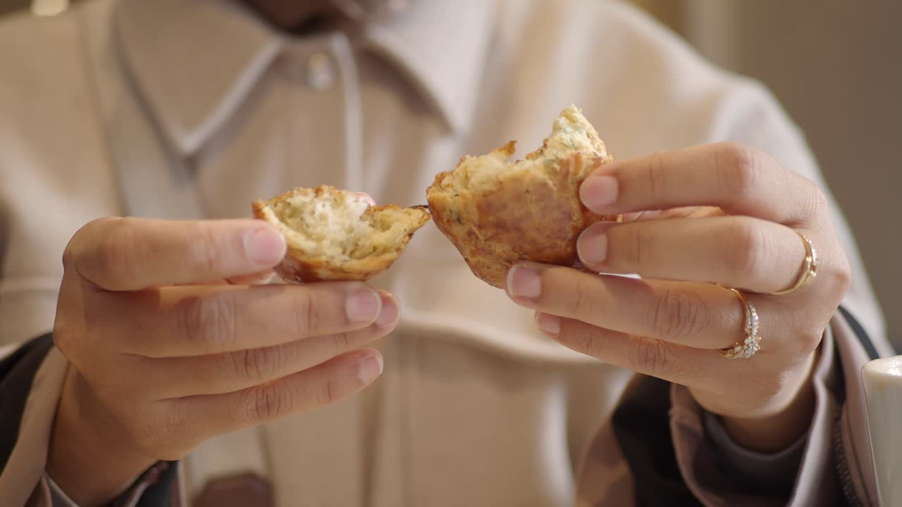 Close-up of Hands Breaking a Freshly Baked Scone