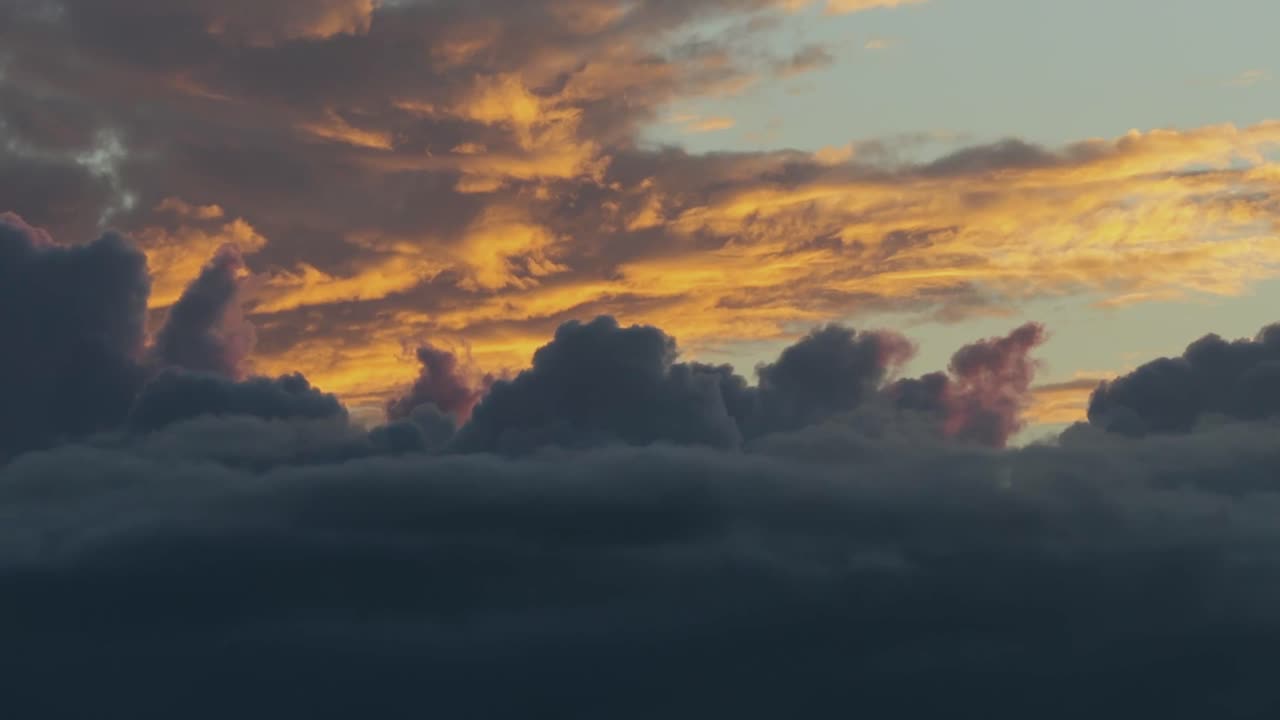Time-lapse of dramatic clouds glowing at sunset over Lanai, Hawaii. Ideal for travel, tourism, or adventure videos—can be sped up for added cinematic effect