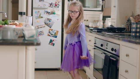 happy ballerina girl dancing in kitchen wearing purple tutu having fun performing funny dance moves enjoying weekend celebration at home