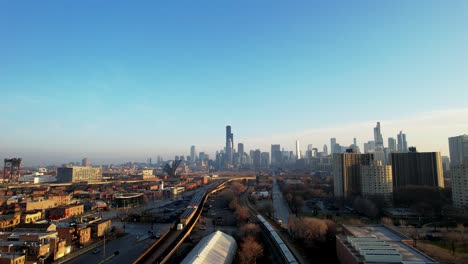 commuter train heading into downtown city of chicago aerial drone