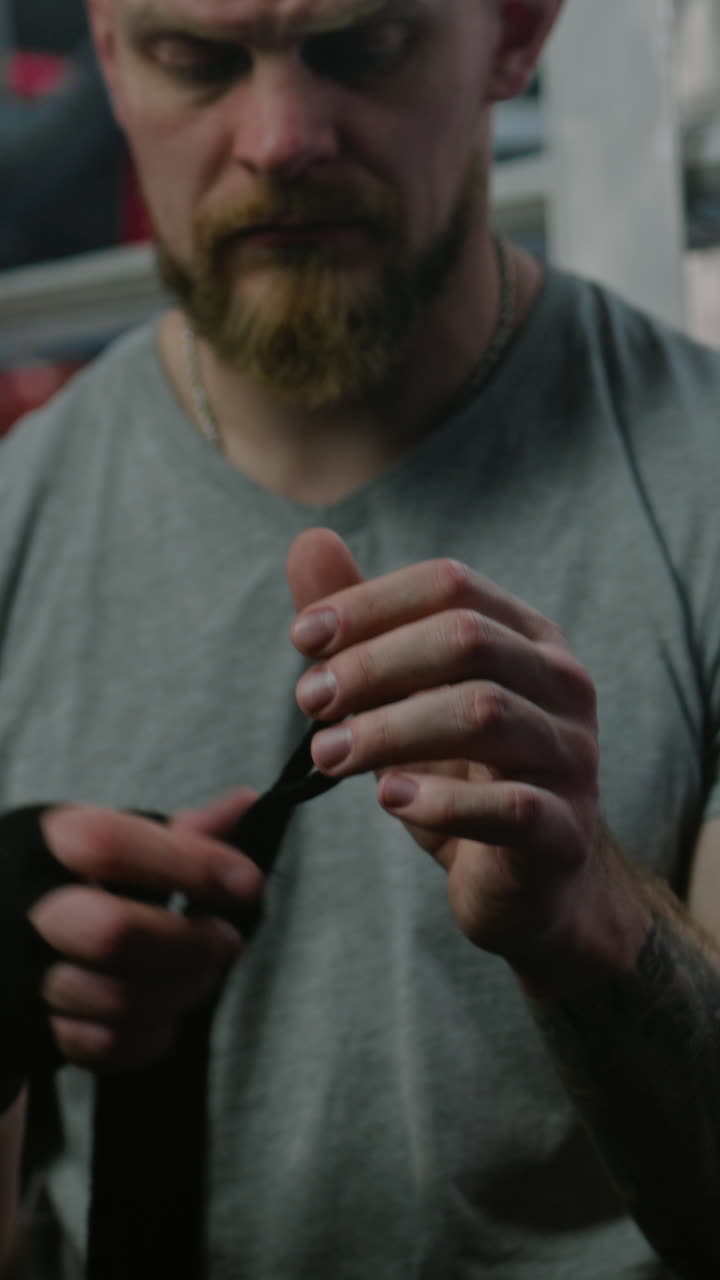 Man putting on boxing wraps