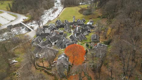 retreating drone shot over the stone houses of the village of cavergno, situated in the district of vallemaggia, in the canton of ticino in switzerland