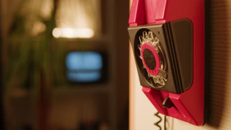 retro vintage phone, red rotary telephone is displayed on a wooden desk, adding a nostalgic touch