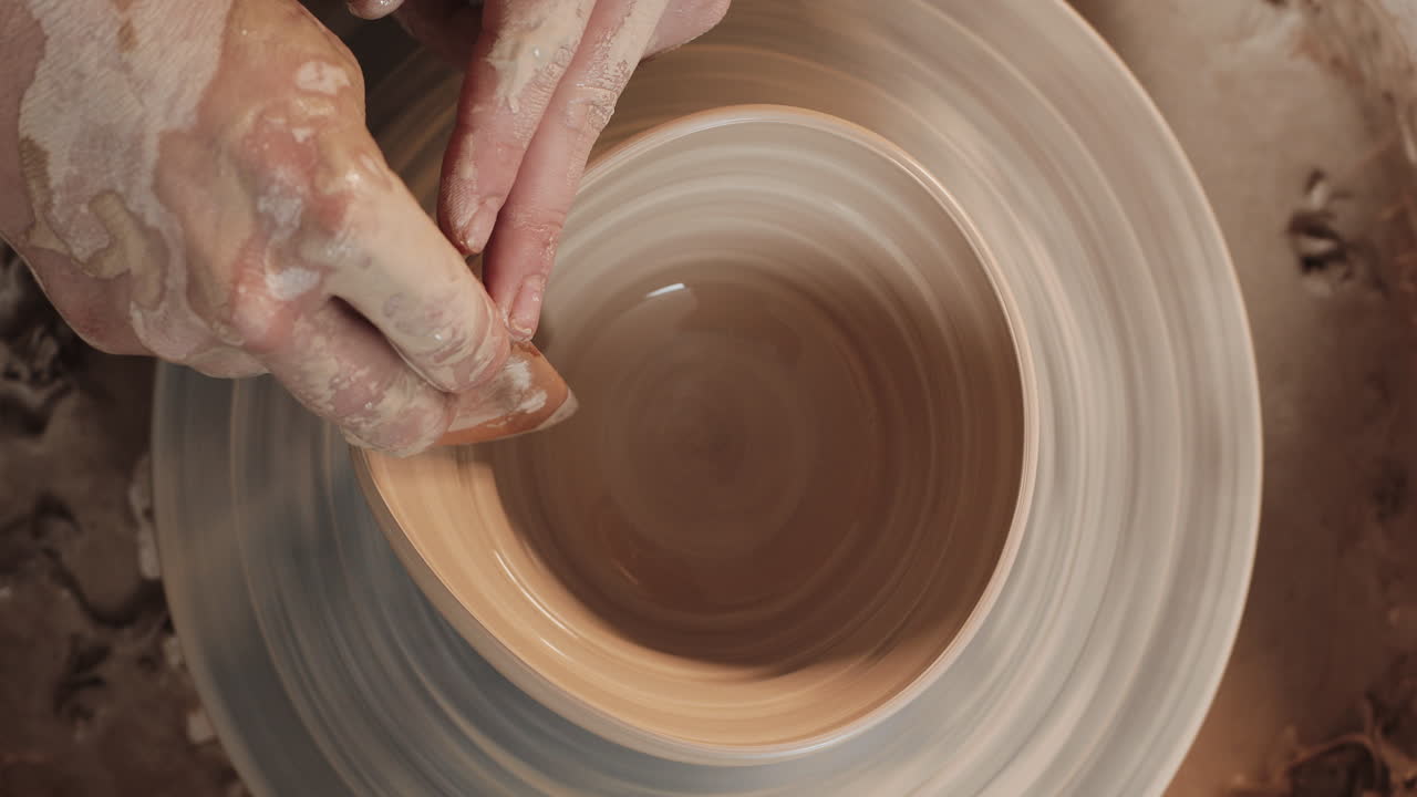 Pottery Artist Shaping a Bowl on a Pottery Wheel
