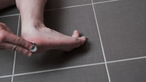 man removing corn, callus from his feet using a razor file, masculine skin care, skin disease, fungal infection, skin treatment