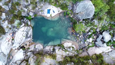 small blue lagoon created from waterfall in peneda geres national park, portugal, europe - drone going up