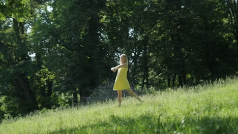 woman in yellow dress dancing gracefully in summer park