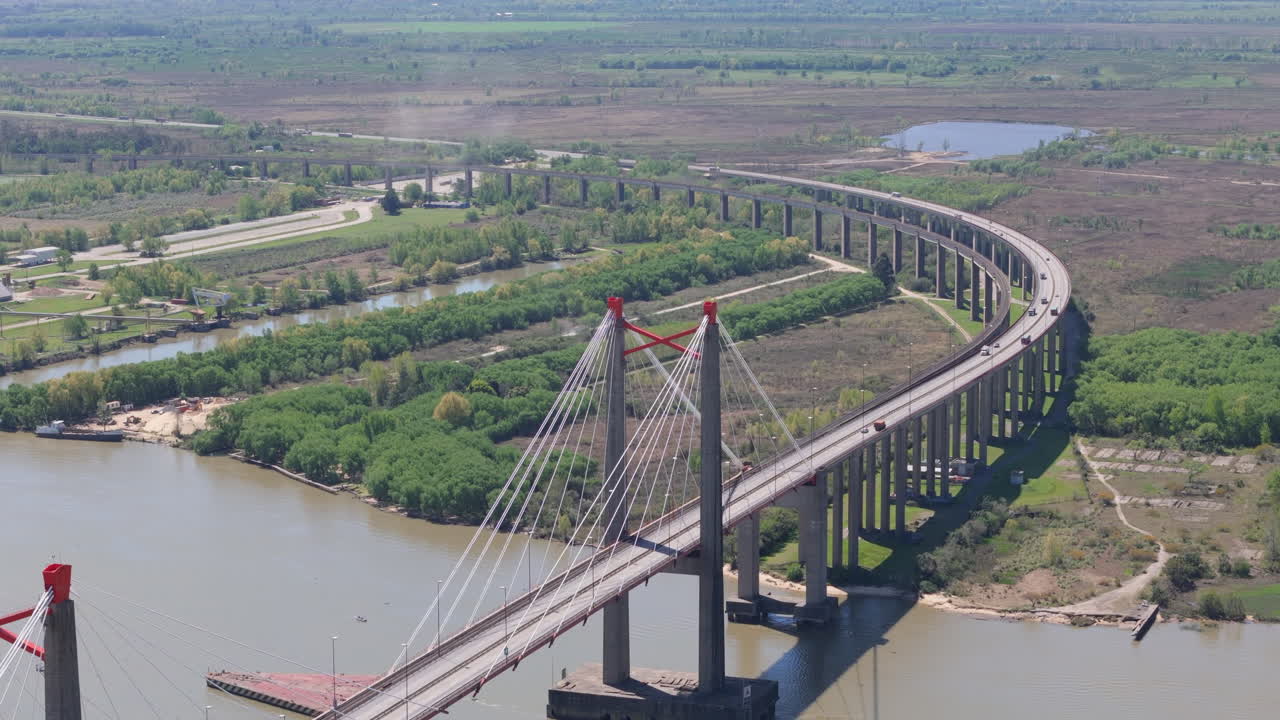 Drone view of Justo Jose de urquiza bridge above the wide Parana Guazu river, a vast waterway, Buenos Aires Argentina. Descending