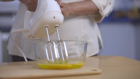 woman-mixing-eggs-with-white-mixer-slow-motion-120-fps