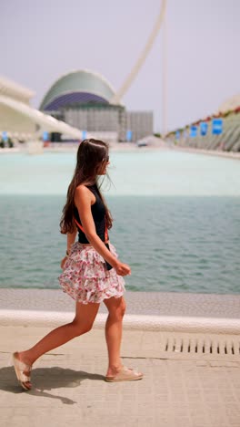 young woman walking in a city park