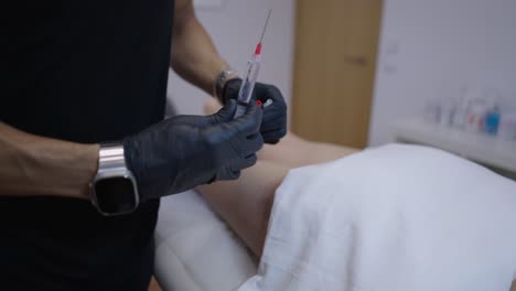medical professional preparing an injection on a patient's leg