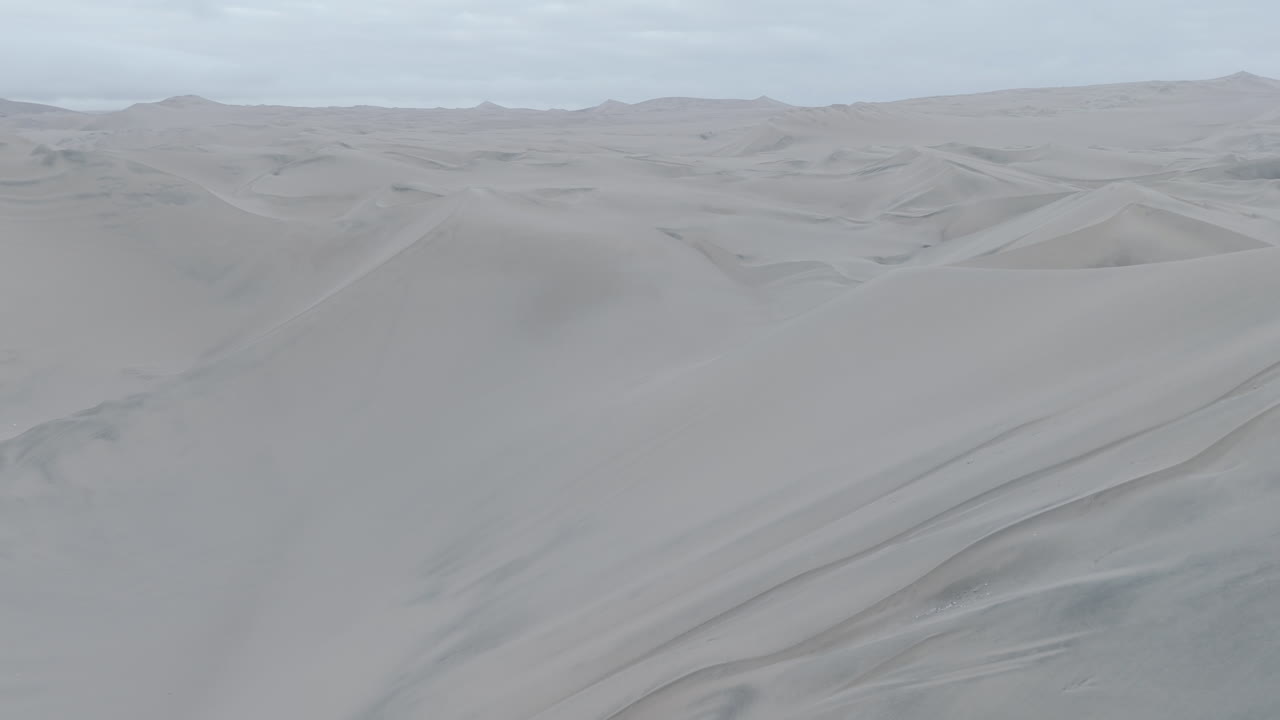 Drone shot above the dunes near Huacachina Peru on a cloudy day in LOG