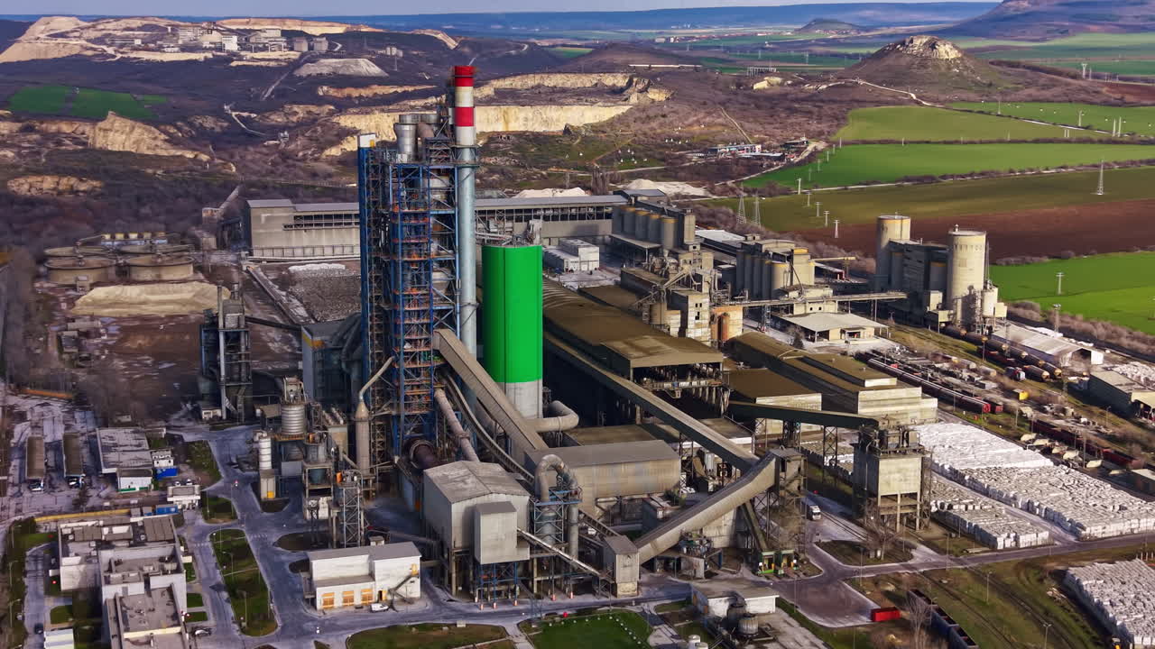 Large industrial plant located in a rural area produces materials during daylight