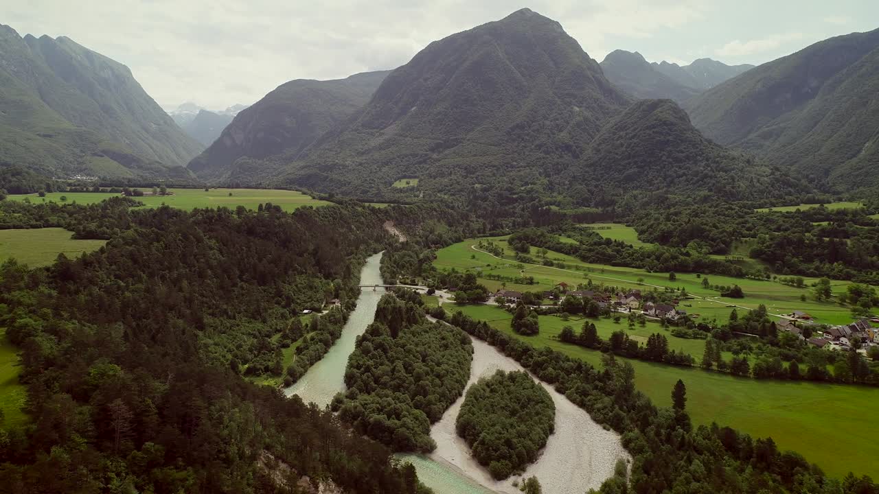 vista aérea de un pequeño pueblo con casas típicas junto al río soca, eslovenia.