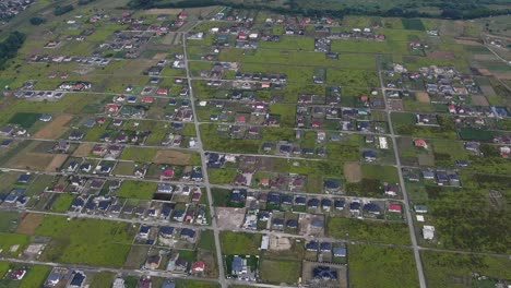 aerial view of eastern europen neighborhood with scattered houses and fields