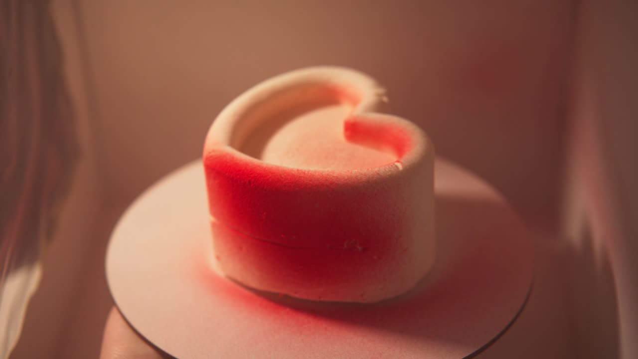 Decorating a White Heart-Shaped Cake with Red Food Coloring