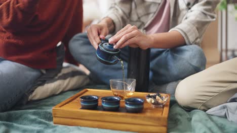friends enjoying a cozy tea ceremony at home