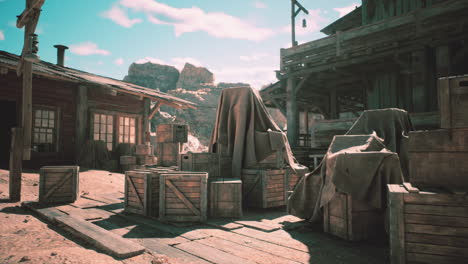 dusty old western town with covered crates and rugged wooden structures